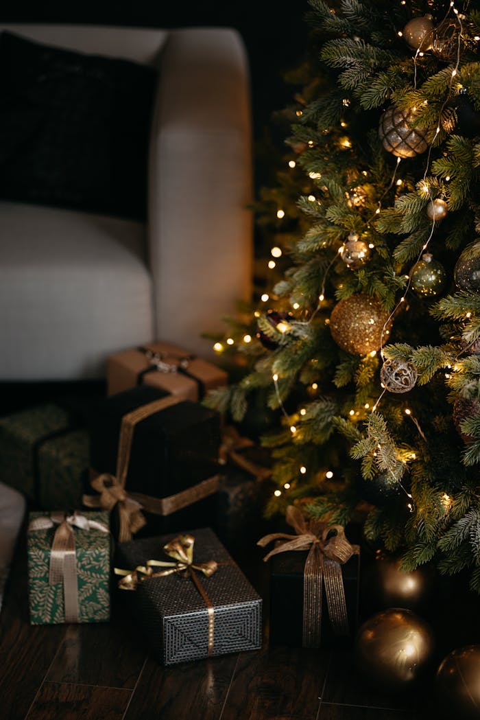 Cozy Christmas scene with a beautifully decorated tree and elegant wrapped presents around an armchair.