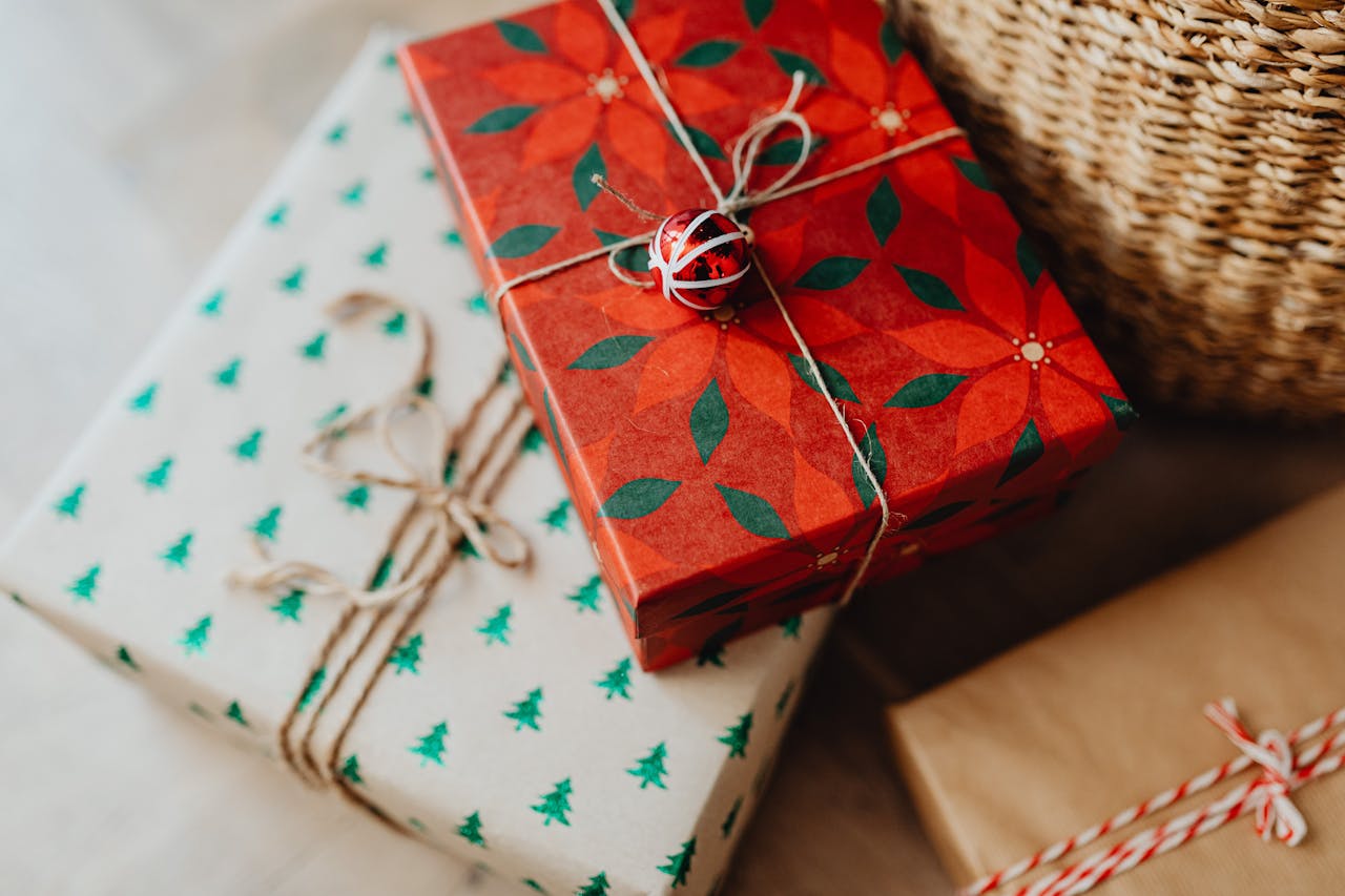 Beautifully wrapped Christmas gifts with vibrant paper and twine.